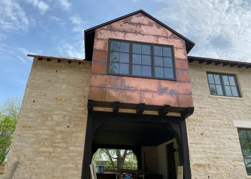 Copper metal panel facade on a stone building for Metal Roof Coating in Luling