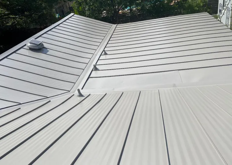Solar attic fan installed on a metal roof for Roof Ventilation in Luling
